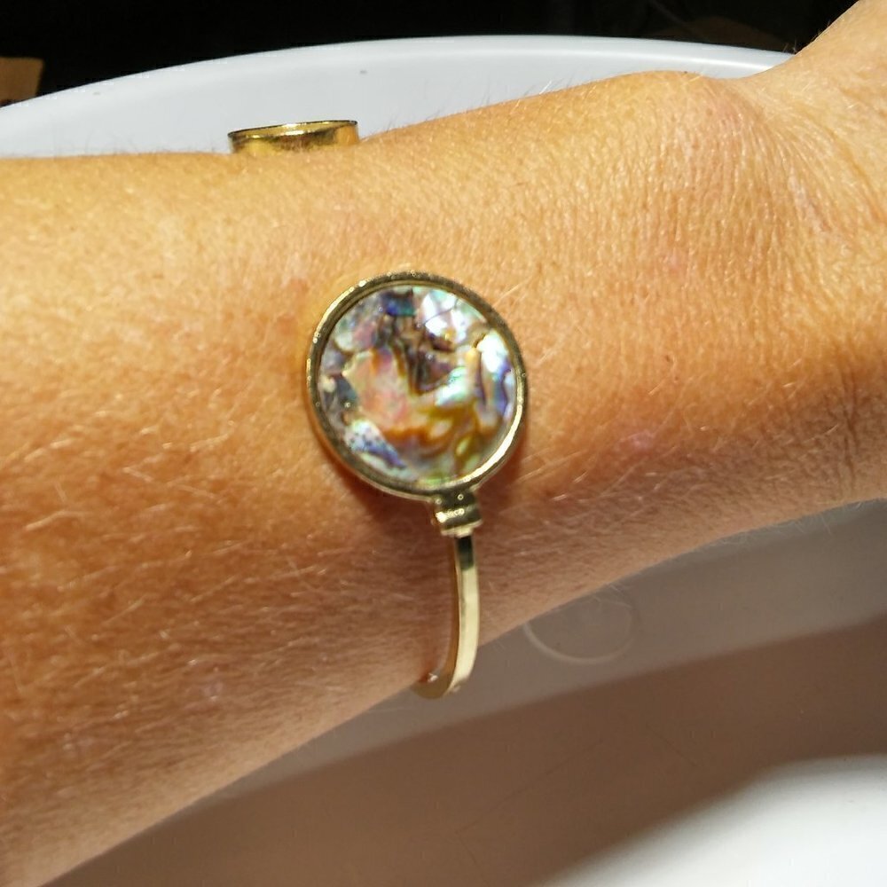 Women`s gold tone faux abalone cuff bracelet.